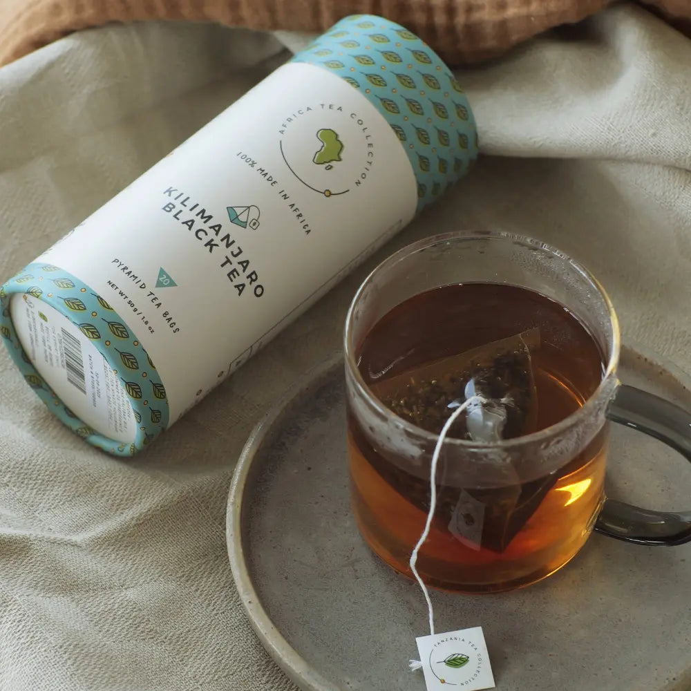 Tea packaging and a cup of tea on a textured surface