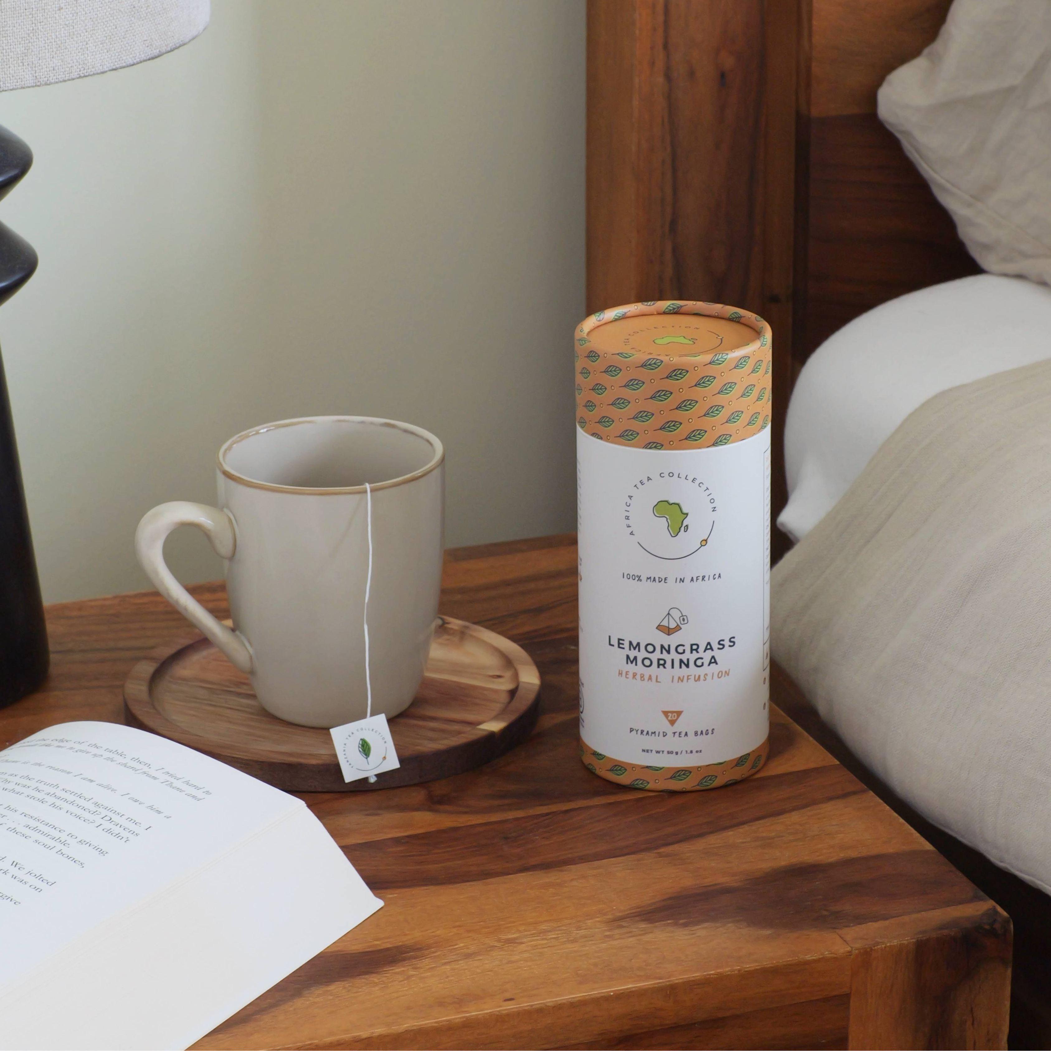 Tea cup with lemon grass moringa tea on a wooden nightstand.
