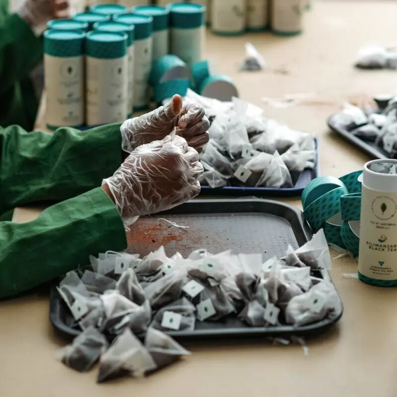 Kazi Yetu factory workers producing biodegradable pryamid tea bags manually