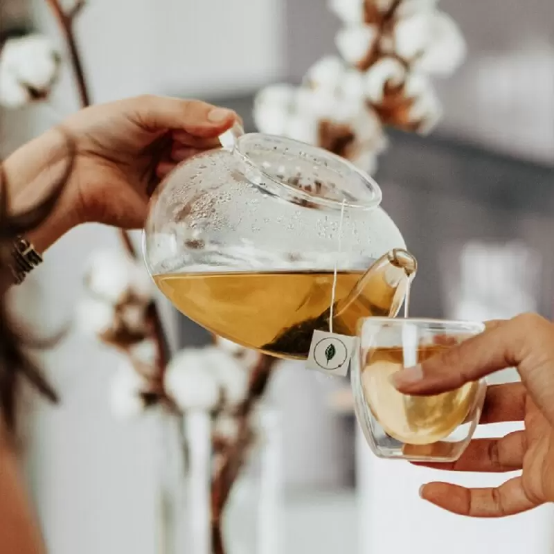 Authenic Ginger Mint Fusion tea being poured form tea pot into cup