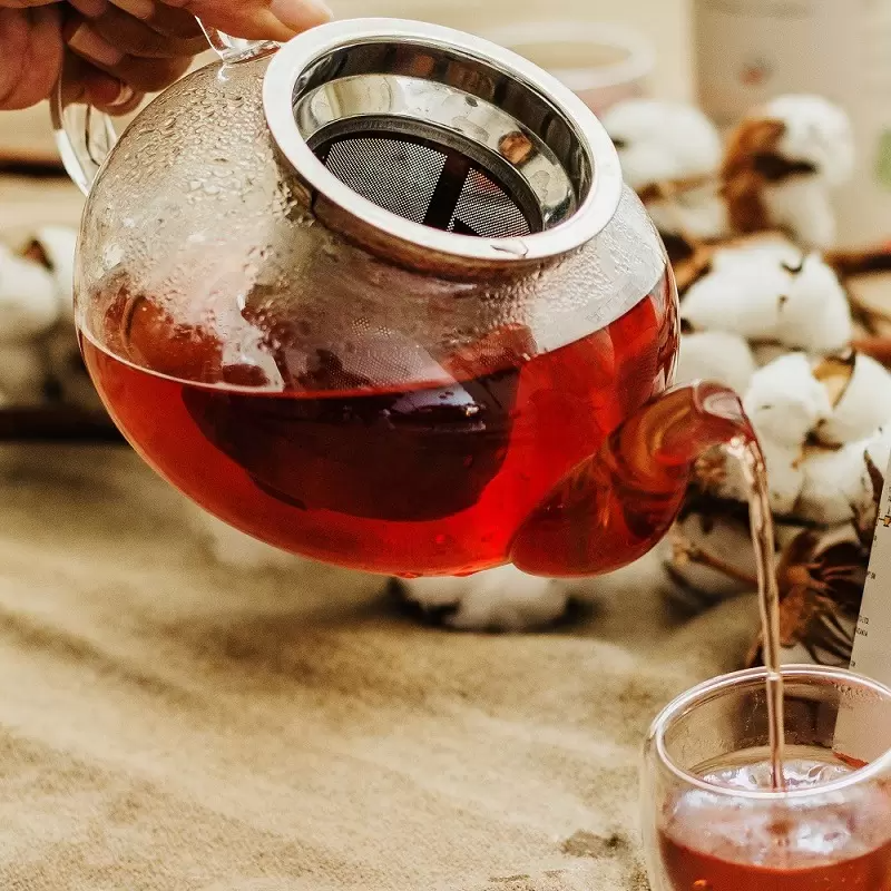 Hibiscus Star tea blend being poured from tea pot into cup