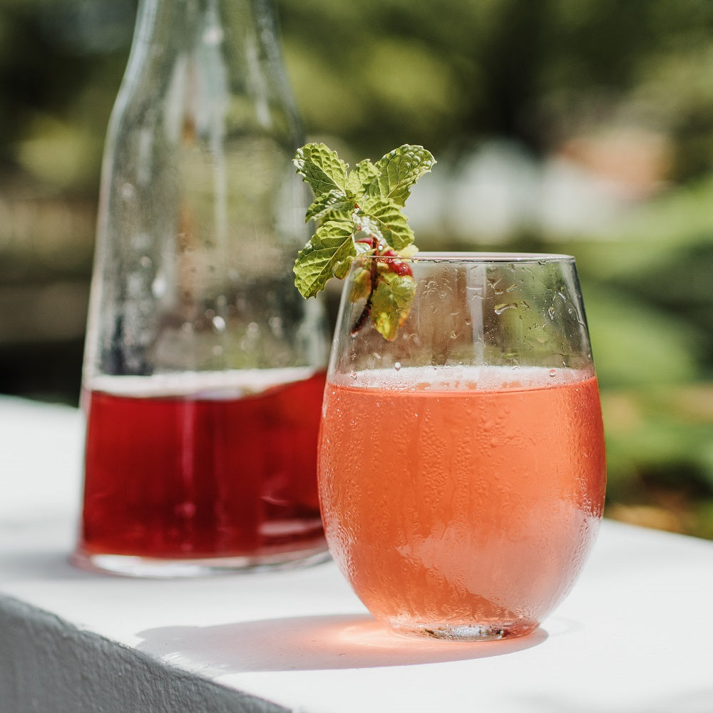 Refreshing Hibiscus Star cold brew ice tea in glass and jug