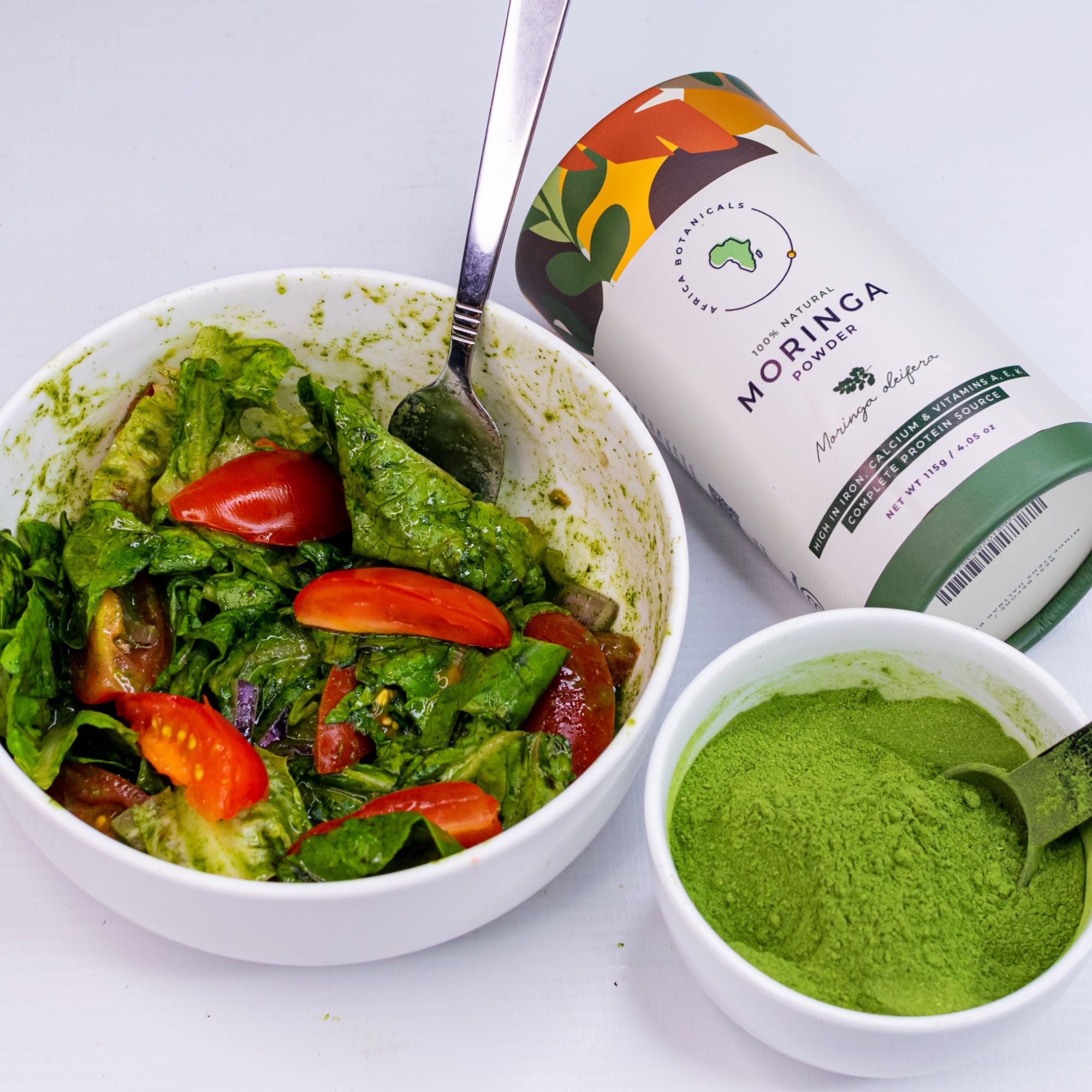 Africa Botanicals moringa poweder shown in bowl and salad recipe