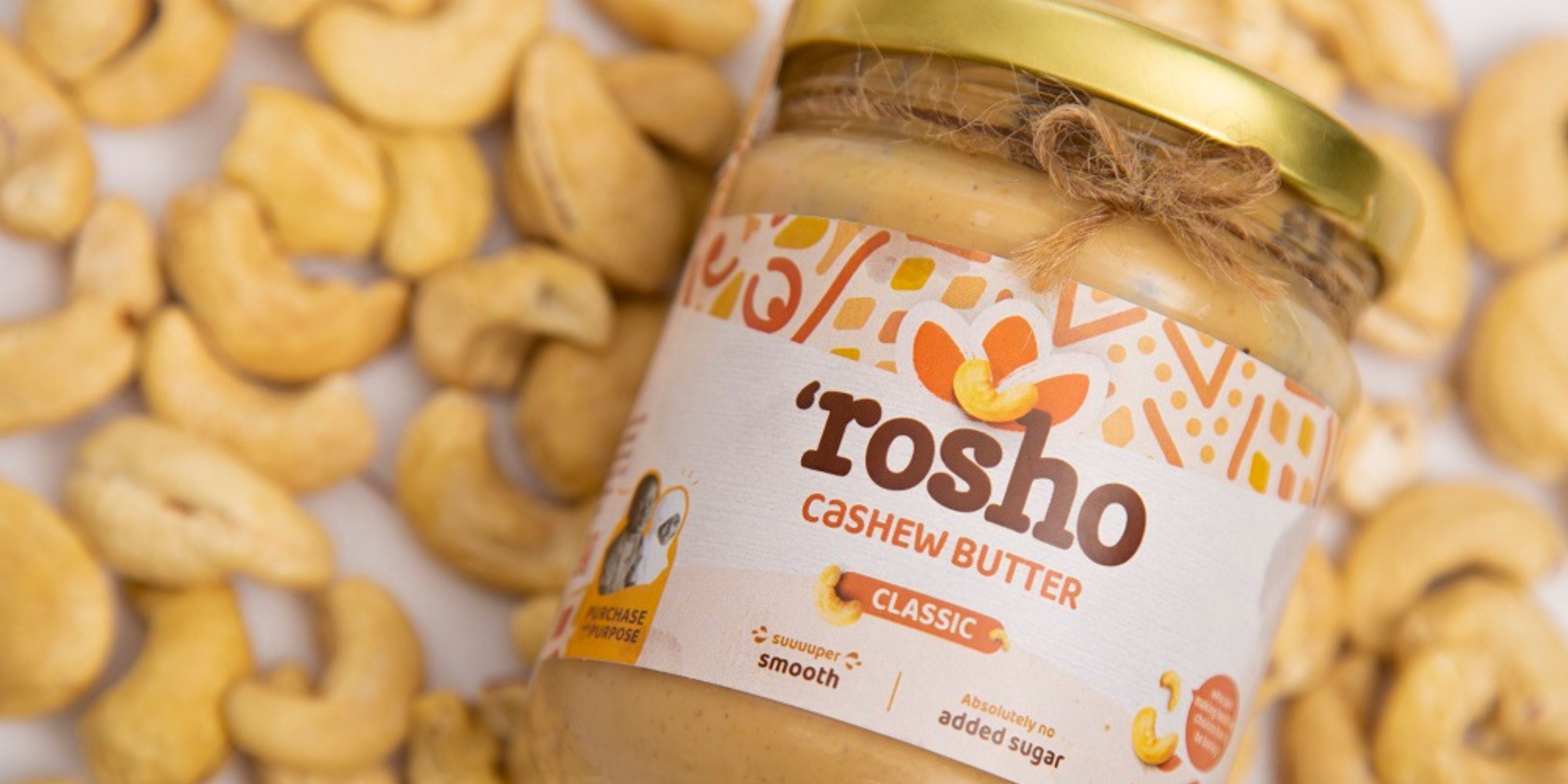 Organic certified cashews in the background and rosho cashew butter jar in the front